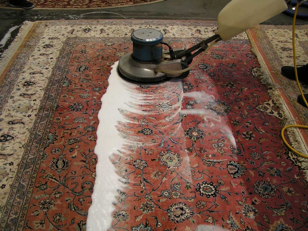 Commercial-grade rotary deep cleaning of a large Persian rug in the East Bay
